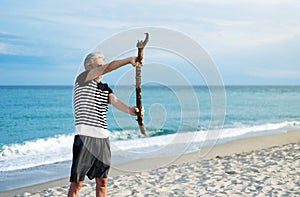 Senior man exercising on the beach