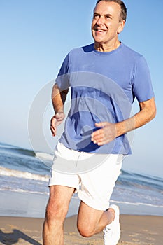 Senior Man Exercising On Beach