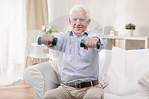 Senior man exercising with dumbbells