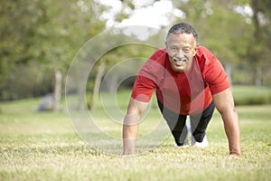 Senior Man Exercising In Park