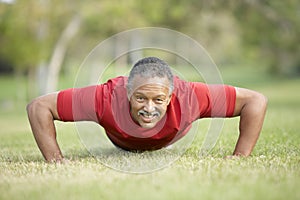 Senior Man Exercising In Park