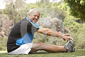 Senior Man Exercising In Park