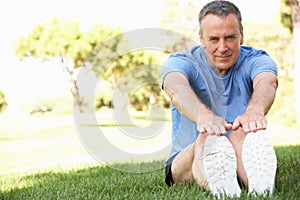 Senior Man Exercising In Park