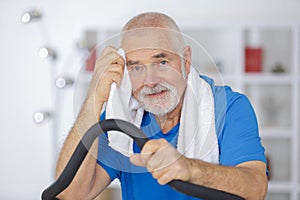 senior man exercising on stepper