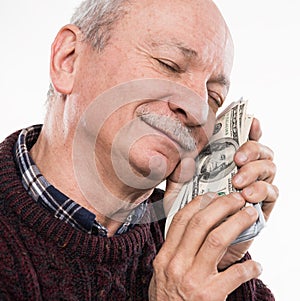 Senior man expressing happiness while posing with dollar and euro bills