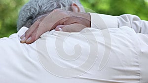 Senior man feeling pain in neck, rheumatism disease, physiotherapy, back view
