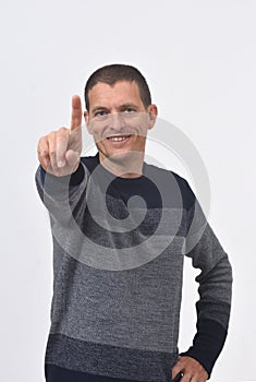 Senior man with finger in the shape of number