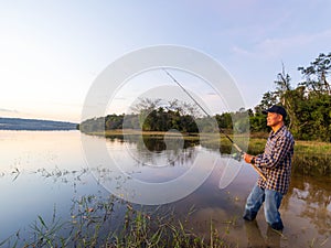 Senior man fishing in a natural river