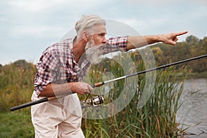 Senior man fishing on the river