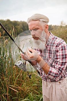 Senior man fishing on the river