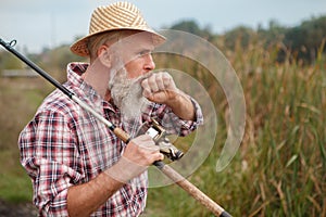 Senior man fishing on the river