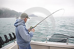 Senior man fishing for salmon in Alaska