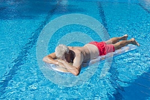 Senior man floating on water