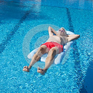 Senior man floating on water