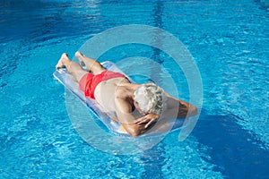 Senior man floating on water