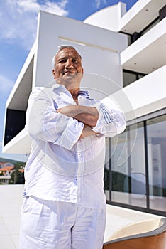 Senior man in front of modern home