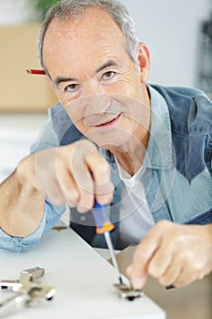 senior man during furniture assembly