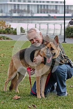 Senior Man and German Sheperd Dog photo