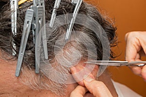 Senior Man getting a haircut at home.