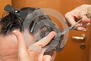 Senior Man getting a haircut at home.