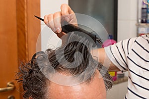 Senior Man getting a haircut at home.