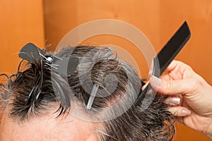 Senior Man getting a haircut at home.