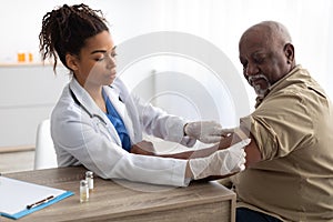 Senior Man Getting Vaccinated Against Covid, Doctor Applying Plaster