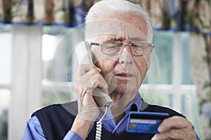 Senior Man Giving Credit Card Details On The Phone