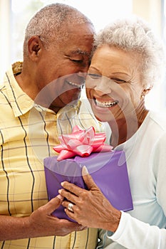 Senior man giving gift to wife