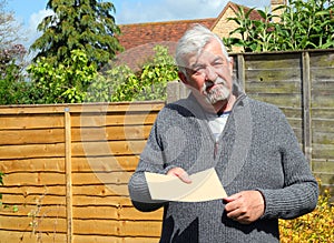 Senior man giving a plain brown envelope.