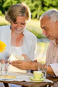 Senior man giving present to his wife