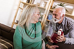 Senior man giving a present to his woman