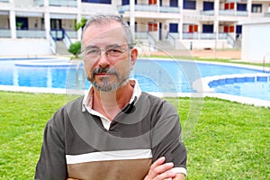 Senior man glasses relax on vacation garden pool