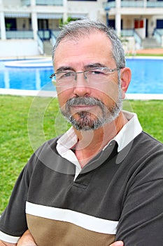 Senior man glasses relax on vacation garden pool