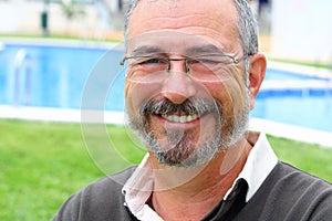 Senior man glasses relax on vacation garden pool