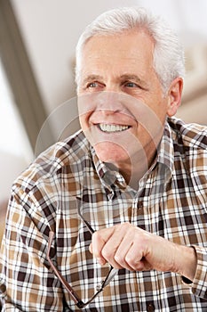 Senior Man With Glasses Relaxing In Chair