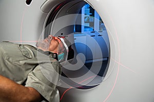 Senior man going through a Computerized Axial Tomography CAT