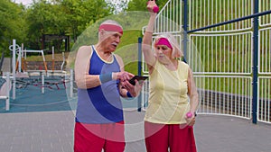 Senior man grandfather coach teaching grandmother with sport weightlifting fitness cardio exercises