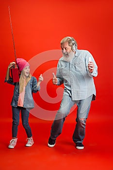 Senior man, grandfather having fun and spending time together with girl, granddaughter. Joyful elderly lifestyle concept