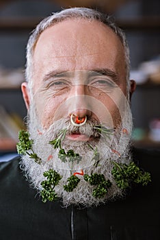 Senior man with greens in beard