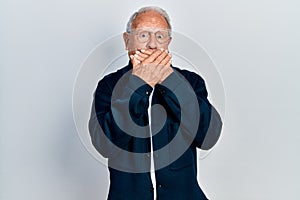 Senior man with grey hair wearing casual style and glasses shocked covering mouth with hands for mistake
