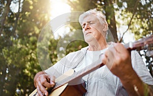 Senior man, guitar and woods for camping, music and relax with freedom, peace and outdoor in summer. Elderly guy