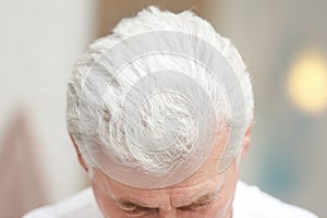 Senior man with hair loss problem indoors