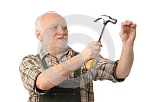 Senior man hammering photo