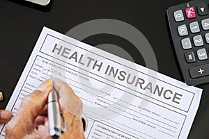 Senior man hand filling health insurance form