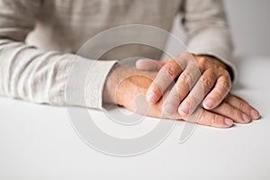 Senior man hands on table