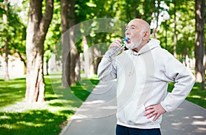 Senior man is having break, drinking water