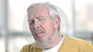 Senior man having breath shortness.