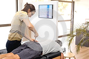 Senior man having chiropractic adjustment.