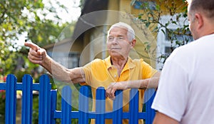 Senior man having conversation with his neighbour